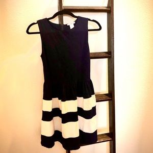 A sleeveless navy blue and white striped dress.